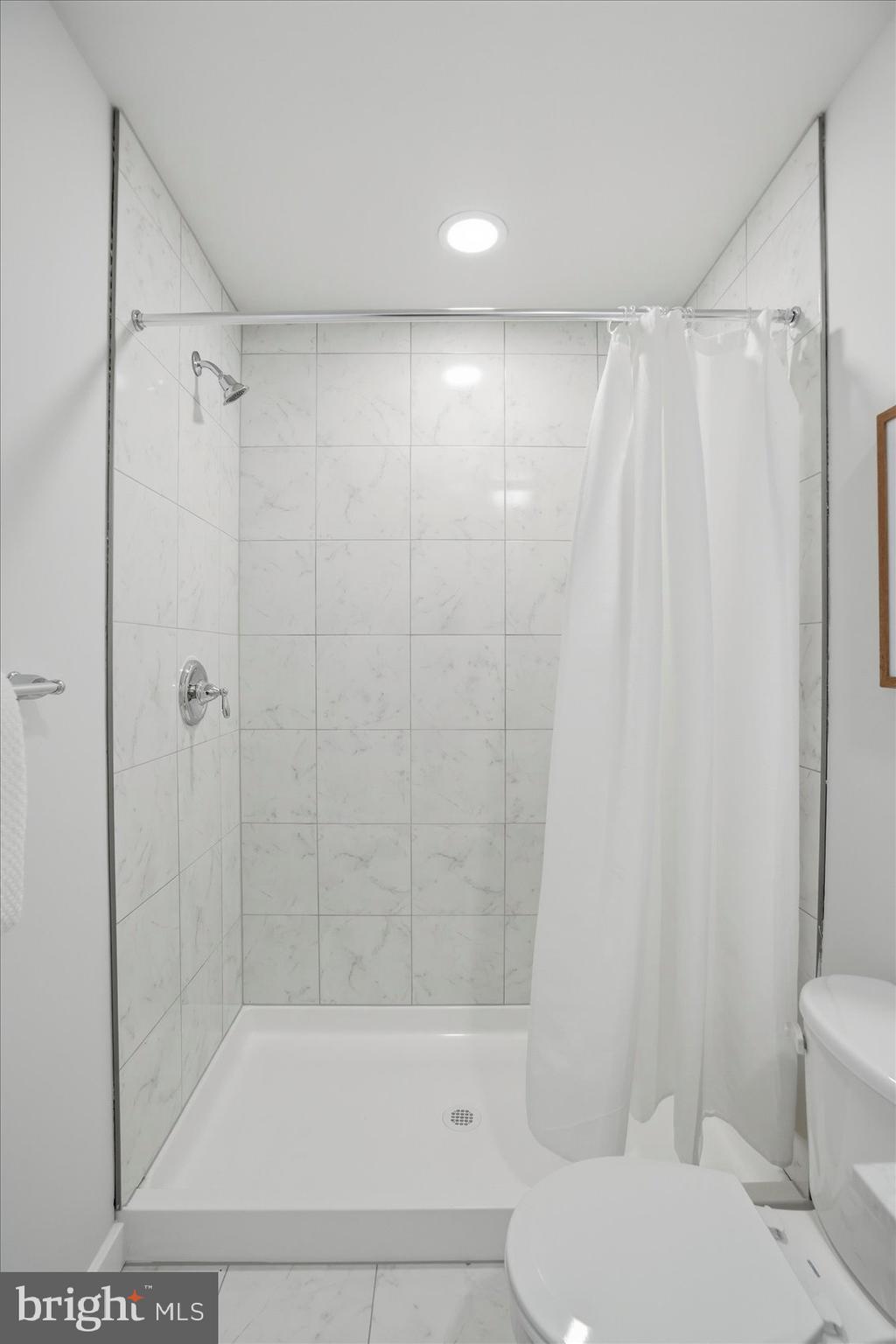 715 Hammonds Lane Baltimore, MD 21225 - Photo 19 of 29 a bathroom with a shower and a toilet