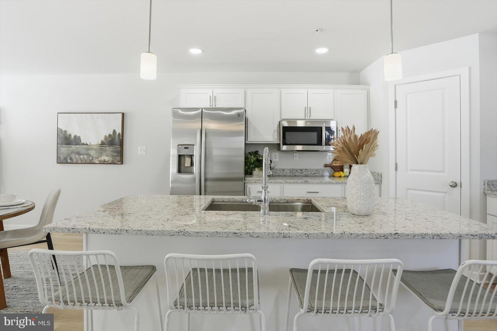 715 Hammonds Lane Baltimore, MD 21225 - Photo 4 of 29 a kitchen with stainless steel appliances granite countertop a sink refrigerator and microwave
