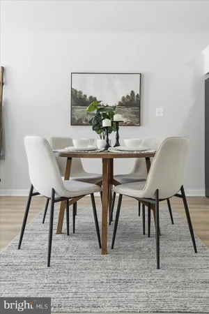 a view of a dining room with furniture and a rug