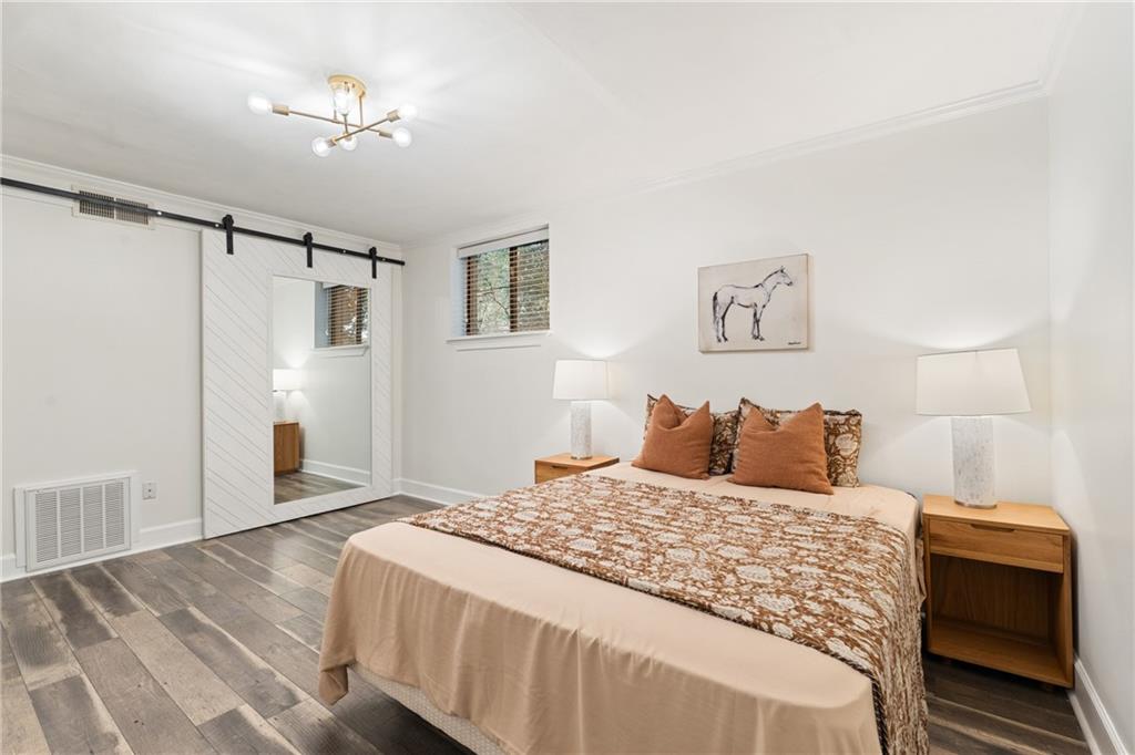 880 Glendale Terrace Northeast, Unit 9 Atlanta, GA 30308 - Photo 14 of 18 a bedroom with a large bed and a chandelier