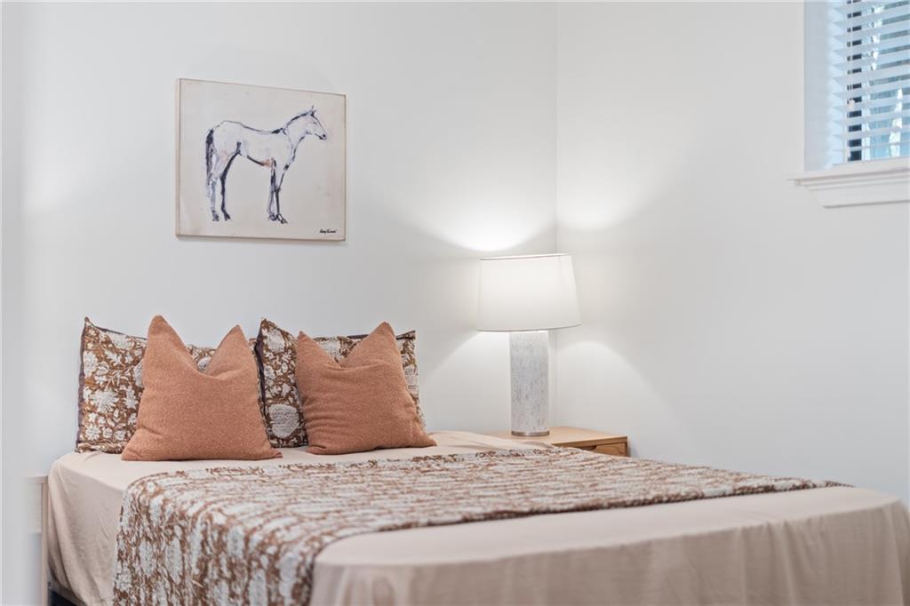 880 Glendale Terrace Northeast, Unit 9 Atlanta, GA 30308 - Photo 15 of 18 a bedroom with a bed and a night stand