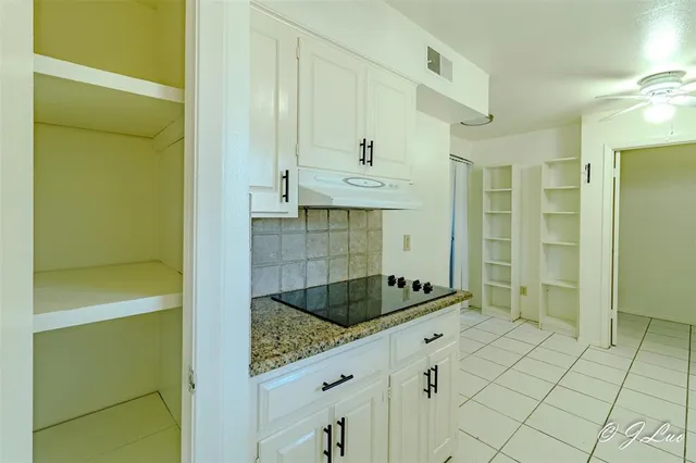 a bathroom with a granite countertop sink and shower