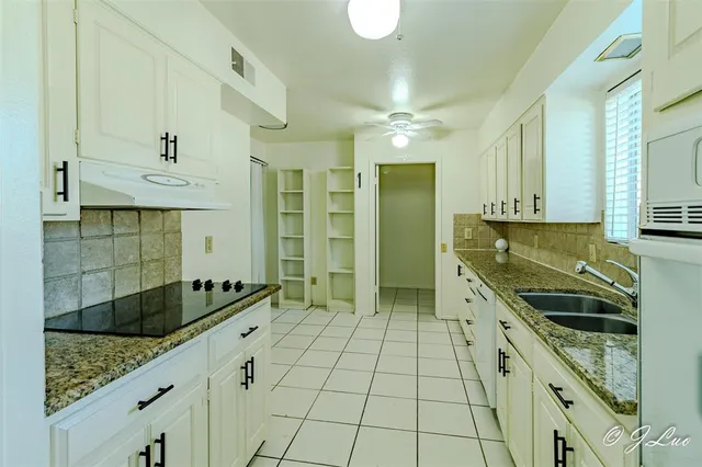 a kitchen with stainless steel appliances a sink and cabinets