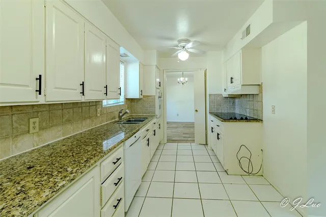 a bathroom with a granite countertop sink mirror and shower