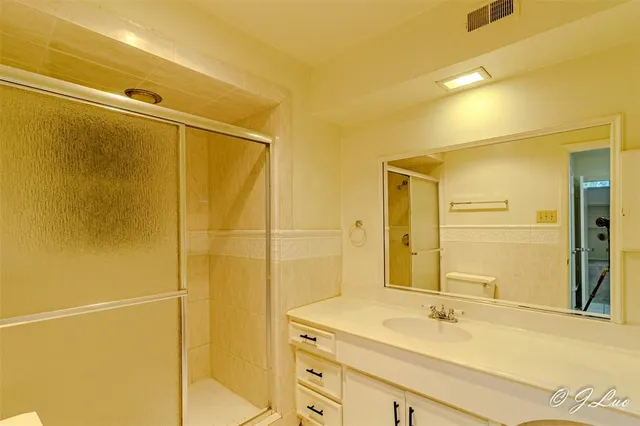 a bathroom with a double vanity sink and a mirror