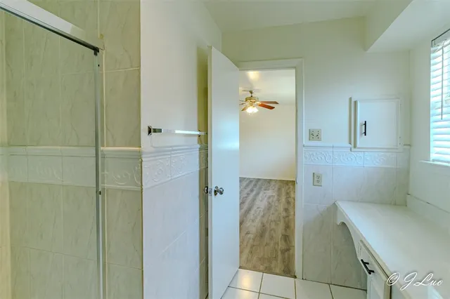 a bathroom with a shower and a sink