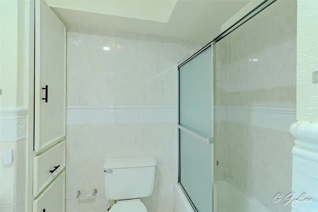 a bathroom with a shower and a toilet