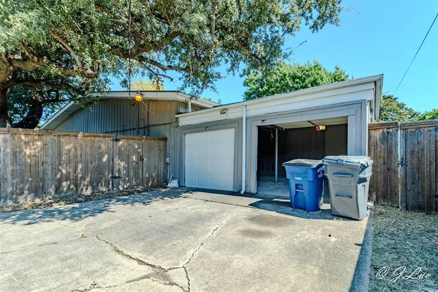 a view of a chair and table in backyard of the house