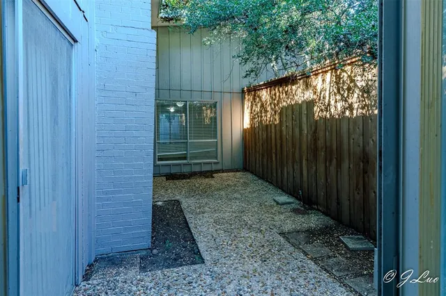 a view of a pathway with a wooden fence