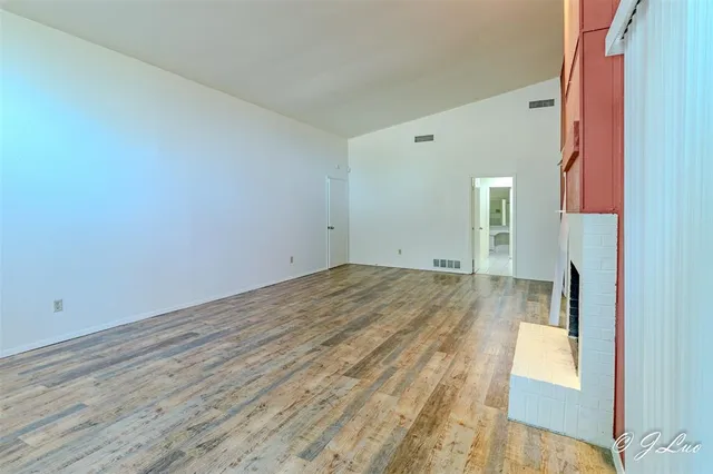 a view of a room with wooden floor and a sink