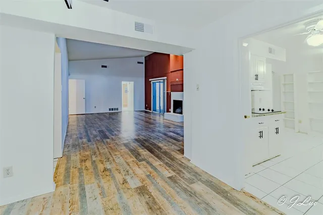a view of a hallway with wooden floor