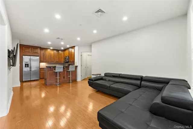a living room with furniture and kitchen view