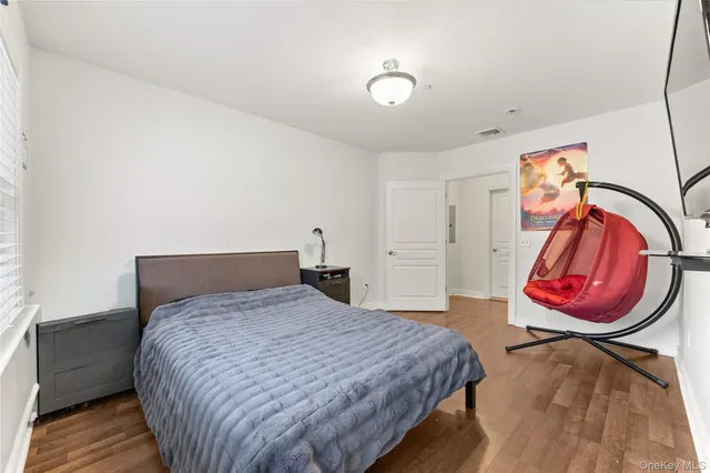a bedroom with a bed and a painting on the wall