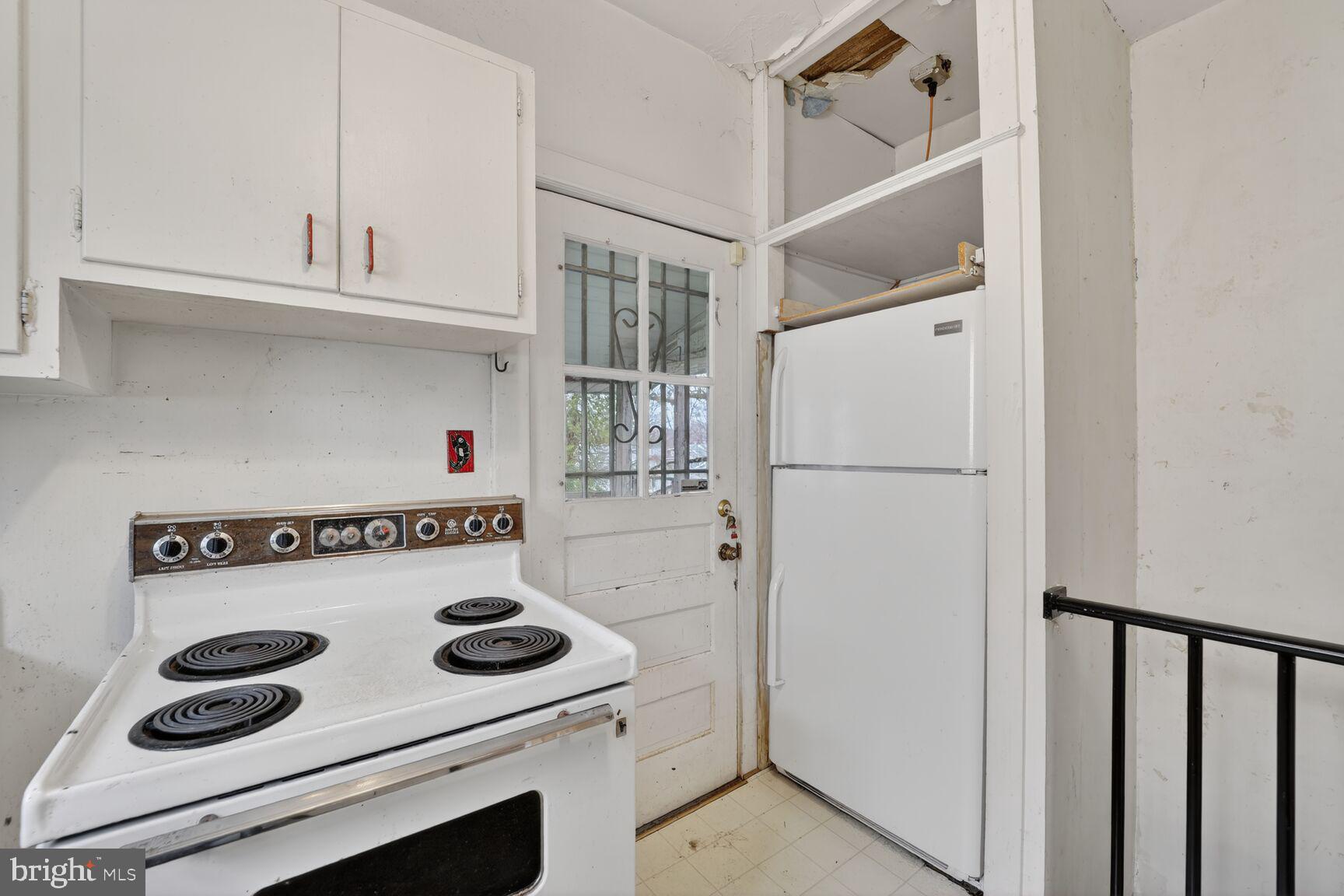 736 Easley Street Silver Spring, MD 20910 - Photo 14 of 51 a kitchen with a refrigerator and white cabinets