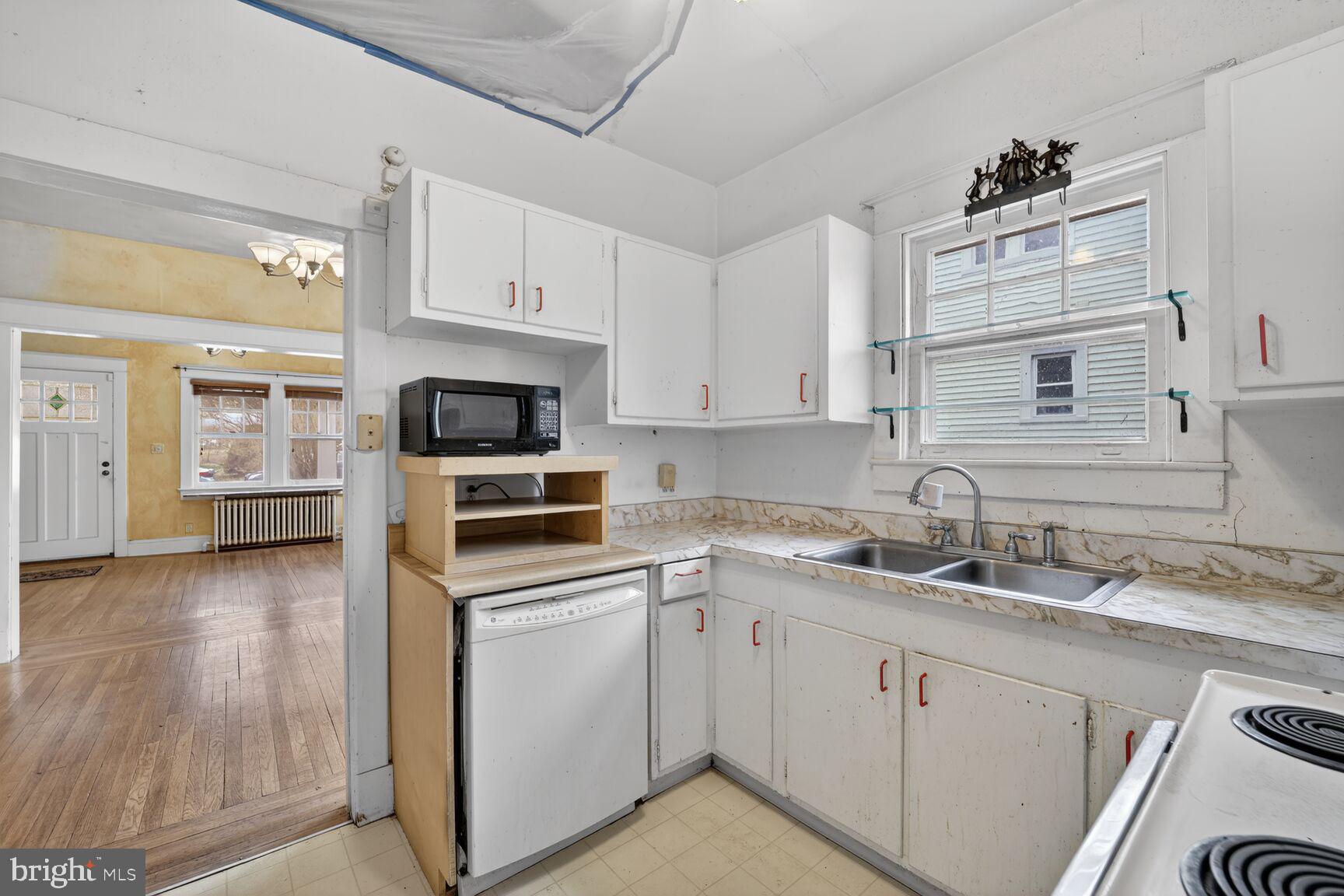 736 Easley Street Silver Spring, MD 20910 - Photo 15 of 51 a kitchen with cabinets stainless steel appliances a sink and wooden floor