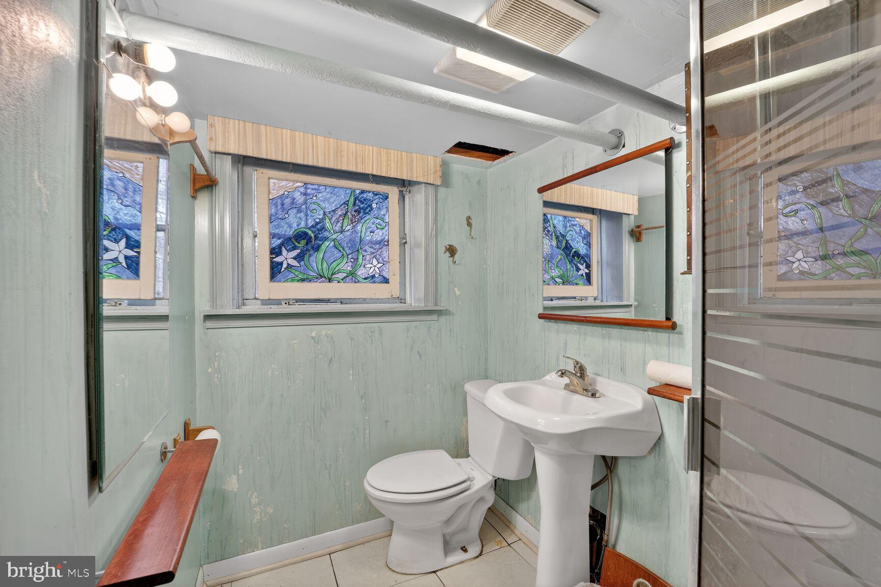 736 Easley Street Silver Spring, MD 20910 - Photo 20 of 51 a bathroom with a toilet a sink and mirror