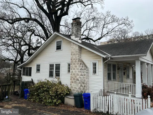a front view of house with yard and trees around