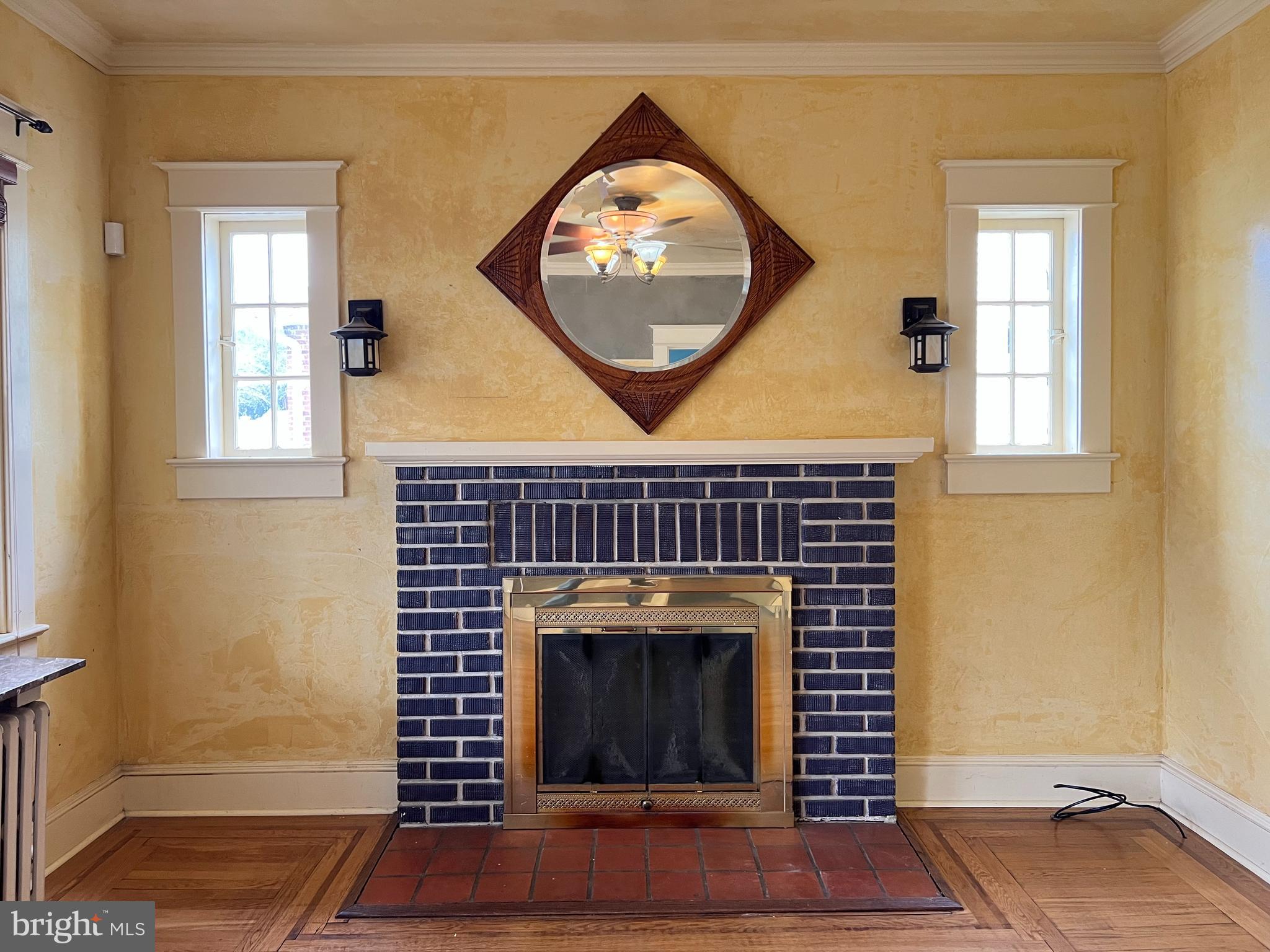736 Easley Street Silver Spring, MD 20910 - Photo 27 of 51 an empty room with wooden floor a fireplace and a window