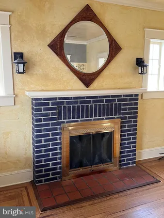 a living room with a fireplace and a rug