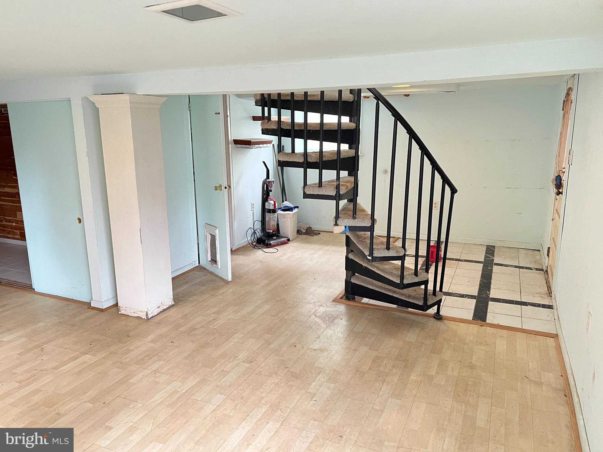 736 Easley Street Silver Spring, MD 20910 - Photo 39 of 51 a view of an empty room with staircase door and windows