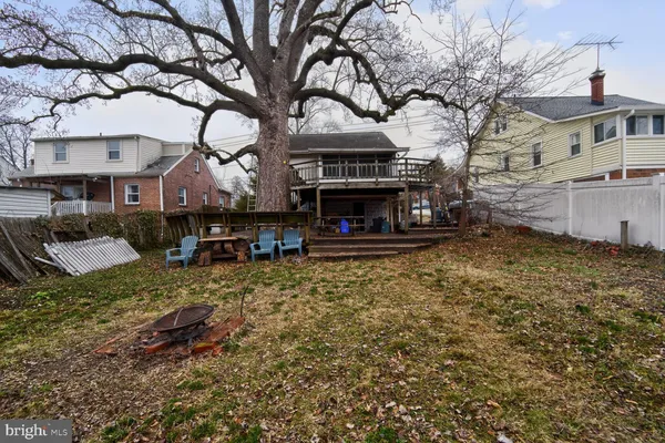 a view of a house with a yard and sitting area
