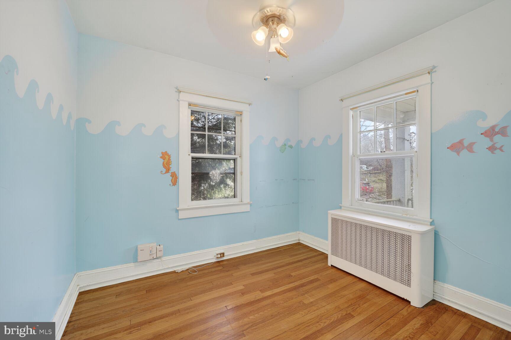 736 Easley Street Silver Spring, MD 20910 - Photo 9 of 51 a bedroom with a bed and wooden floor