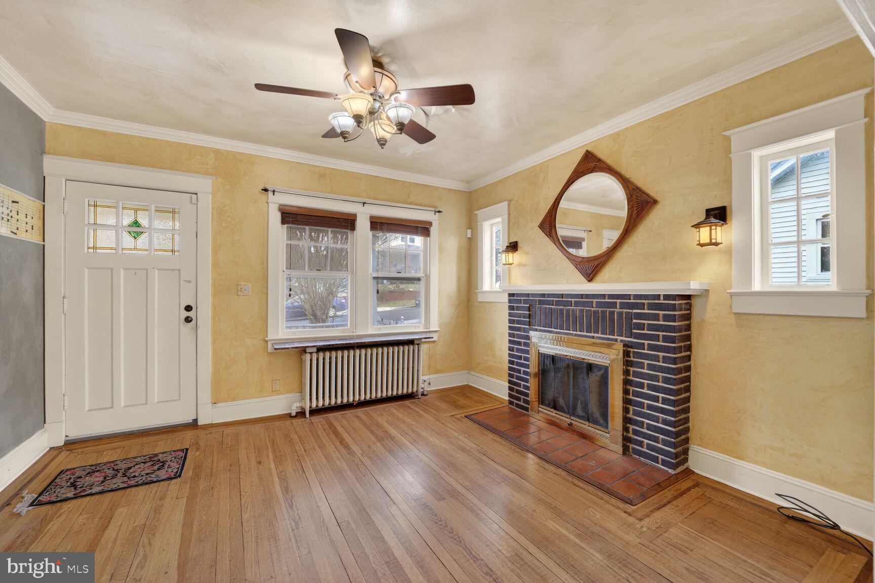 736 Easley Street Silver Spring, MD 20910 - Photo 10 of 51 a view of an empty room with wooden floor fireplace and a window