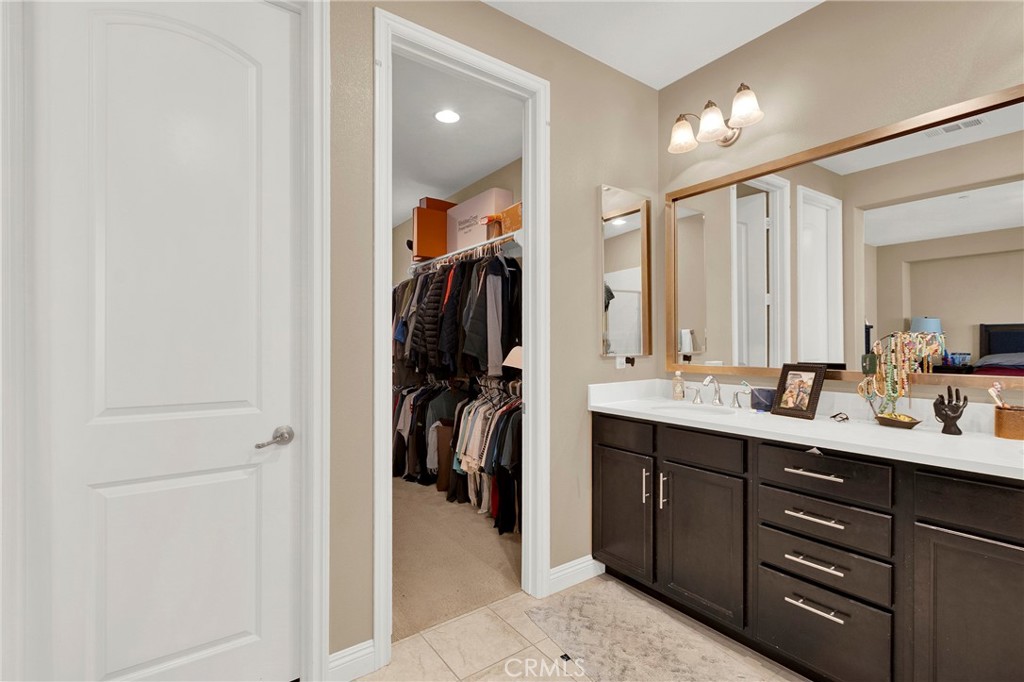 2 Sevilla Rancho Santa Margarita, CA 92688 - Photo 18 of 32 a en suite bathroom with a double vanity sink and mirror