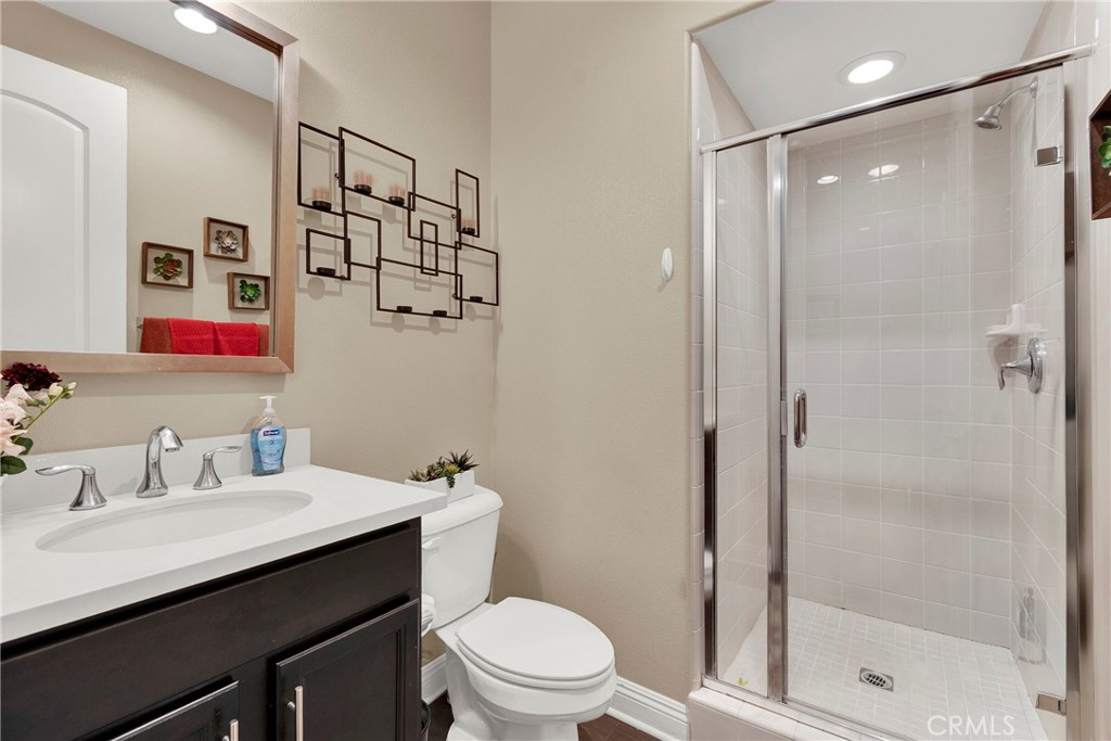 2 Sevilla Rancho Santa Margarita, CA 92688 - Photo 22 of 32 a bathroom with a shower sink vanity mirror and toilet