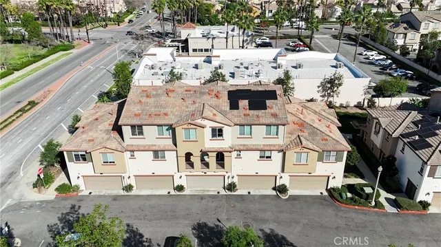 an aerial view of a house with yard and mountain view in back