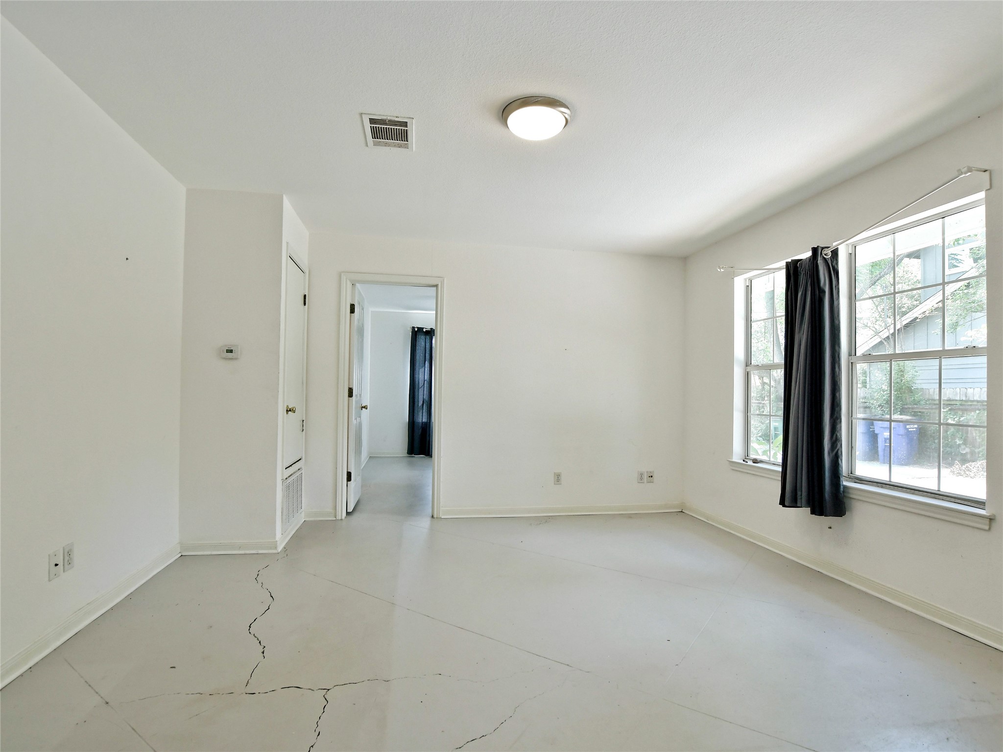 4604 Red River Street, Unit A Austin, TX 78751 - Photo 3 of 15 Neutral-toned room with white walls, light-colored flooring, and a flush mount ceiling light