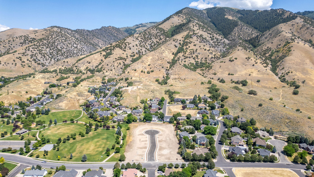 1473 Red Fox Court, Unit 4 Logan, UT 84321 - Photo 4 of 19 Aerial perspective showcasing a residential development nestled at the base of expansive mountains