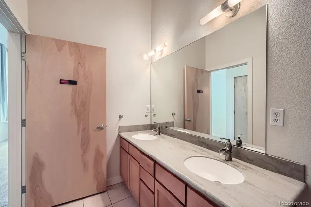 a bathroom with 2 sink and a mirror