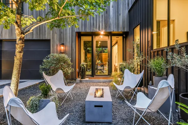 a view of an outdoor sitting area with furniture and tub