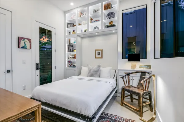 a bedroom with a bed and a table in it