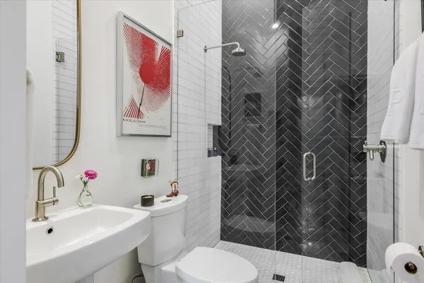 a bathroom with a sink toilet and shower