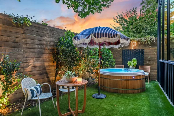 a view of a chair and table in backyard