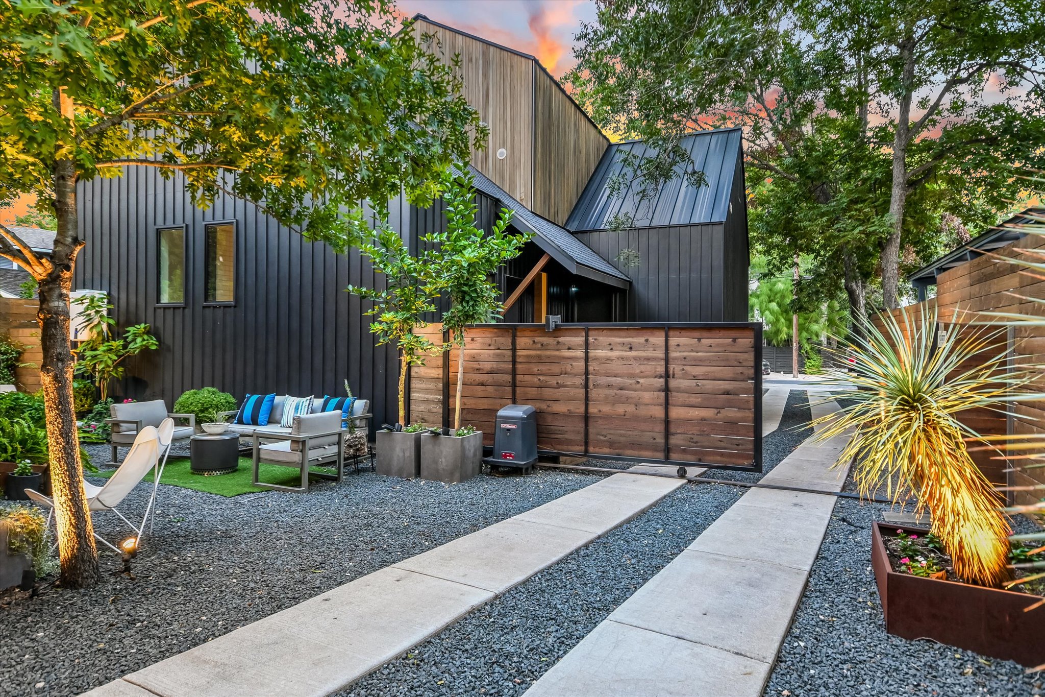 2212 South 2nd Street, Unit 2 Austin, TX 78704 - Photo 23 of 23 a view of a backyard with chairs potted plants and wooden fence
