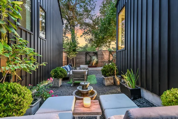 a view of backyard with outdoor seating and plants