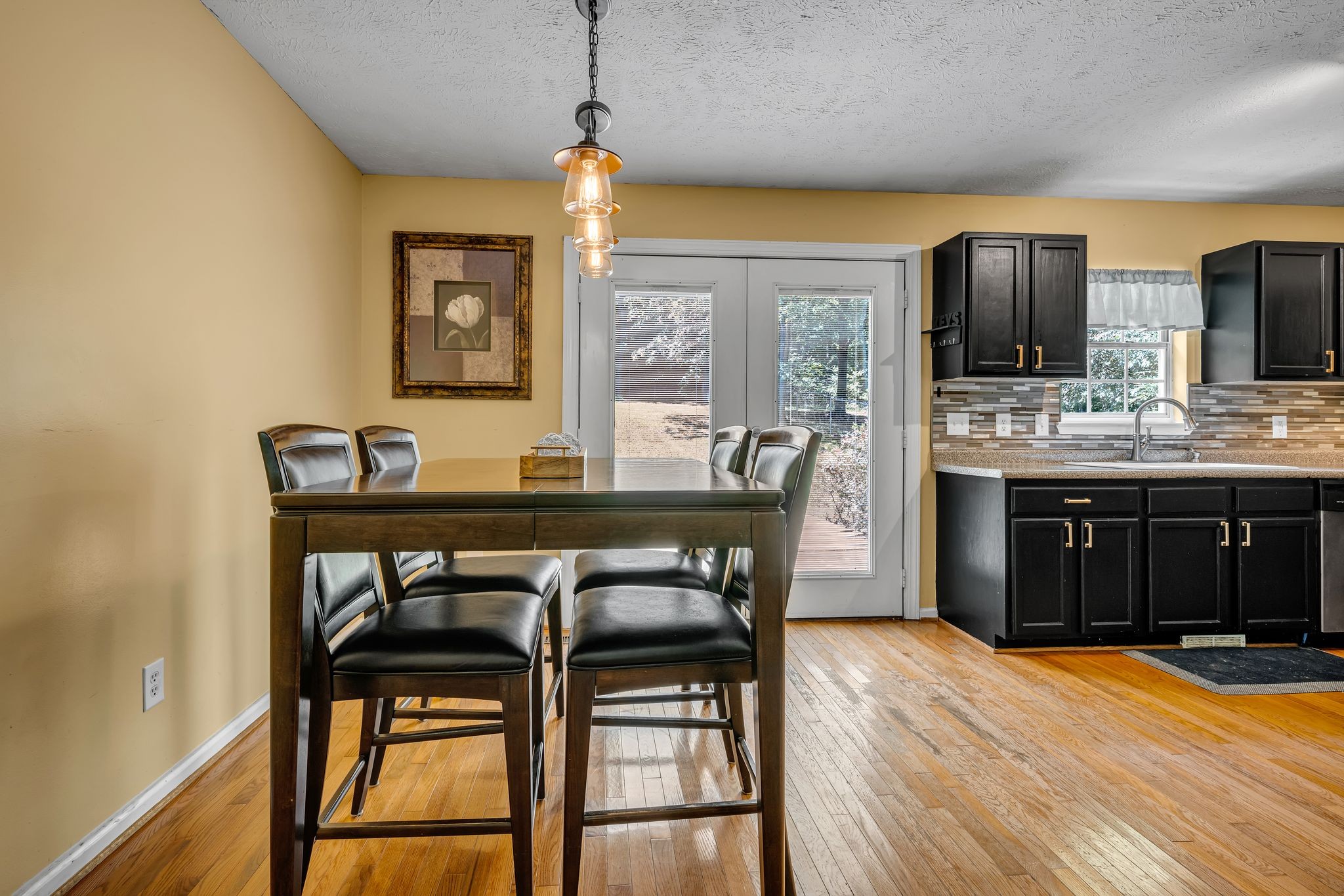 190 Gaskins Road Dickson, TN 37055 - Photo 11 of 25 a dining room with wooden floor a chandelier a wooden table and chairs