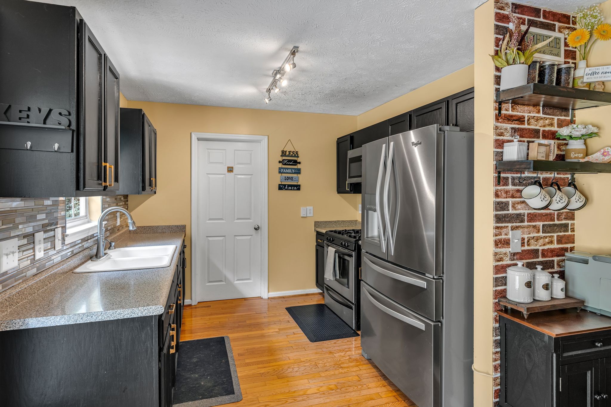 190 Gaskins Road Dickson, TN 37055 - Photo 7 of 25 a kitchen with granite countertop a refrigerator and a sink