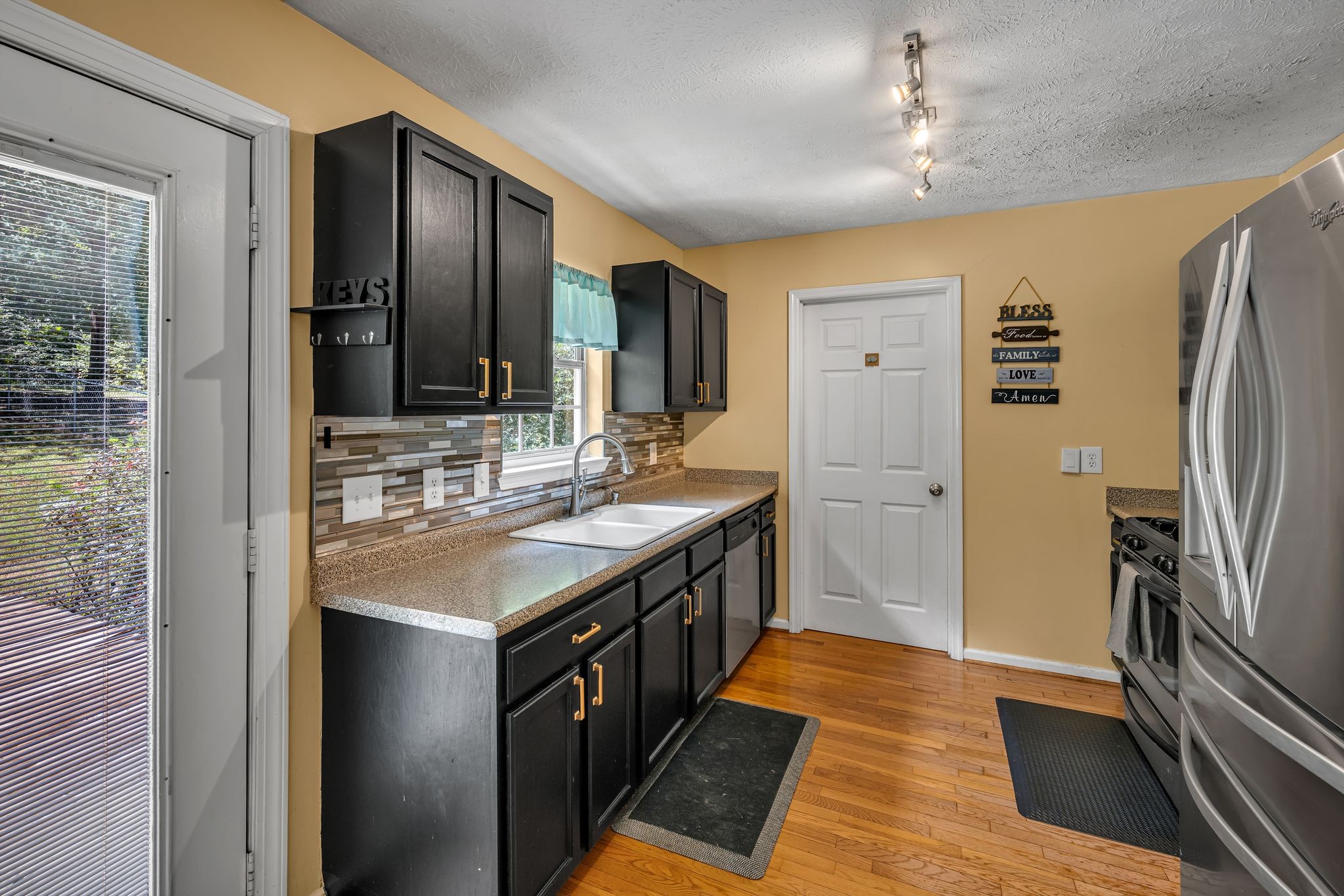 190 Gaskins Road Dickson, TN 37055 - Photo 9 of 25 a kitchen with stainless steel appliances granite countertop a sink and refrigerator