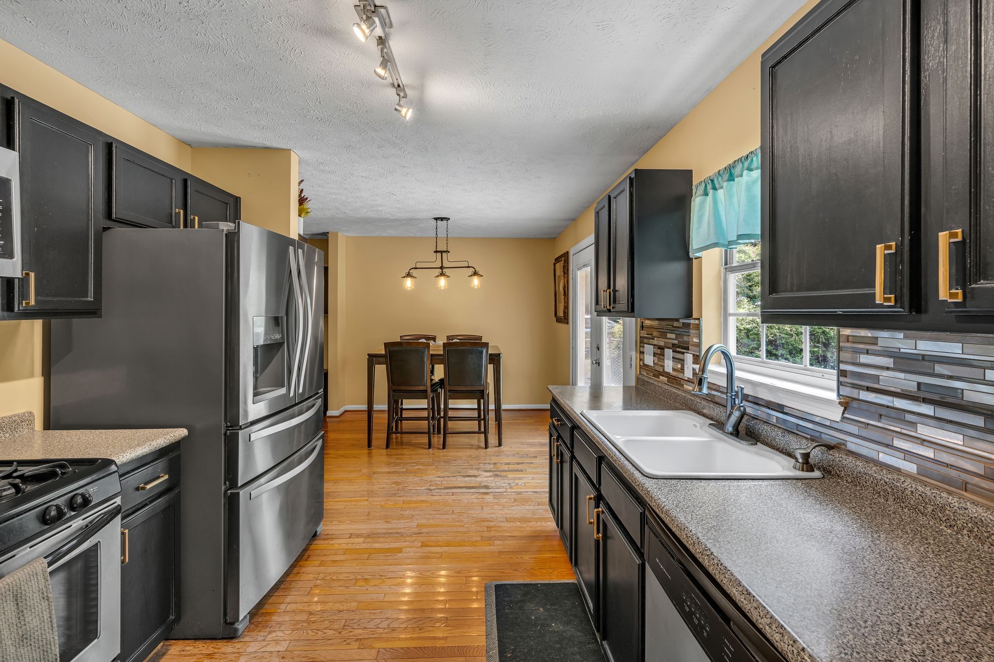 190 Gaskins Road Dickson, TN 37055 - Photo 10 of 25 a kitchen with stainless steel appliances granite countertop a sink stove and refrigerator