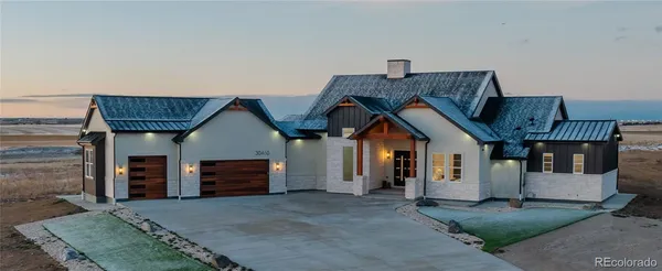 a dining hall with couches a flat tv screen and a dining table with wooden floor