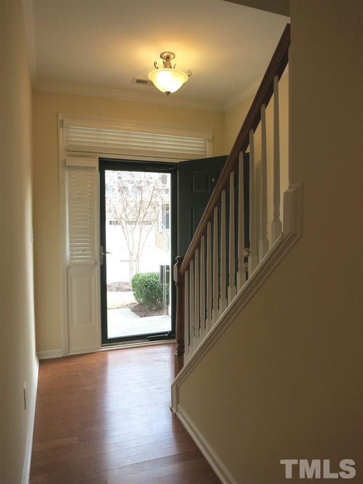 View of the Foyer. There are hardwood flrs in the Foyer, Living Rm, Dining Rm & Kitchen; and custom 2” blinds & upgraded CFs in all rooms.