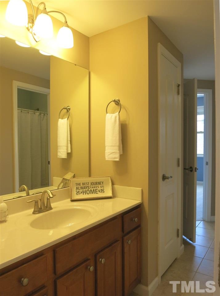 8357 Primanti Boulevard Raleigh, NC 27612 - Photo 21 of 25 The unique, tiled ‘Buddy Bath’ is accessed by both upstairs Bedrooms, the Loft & Bonus Rm.