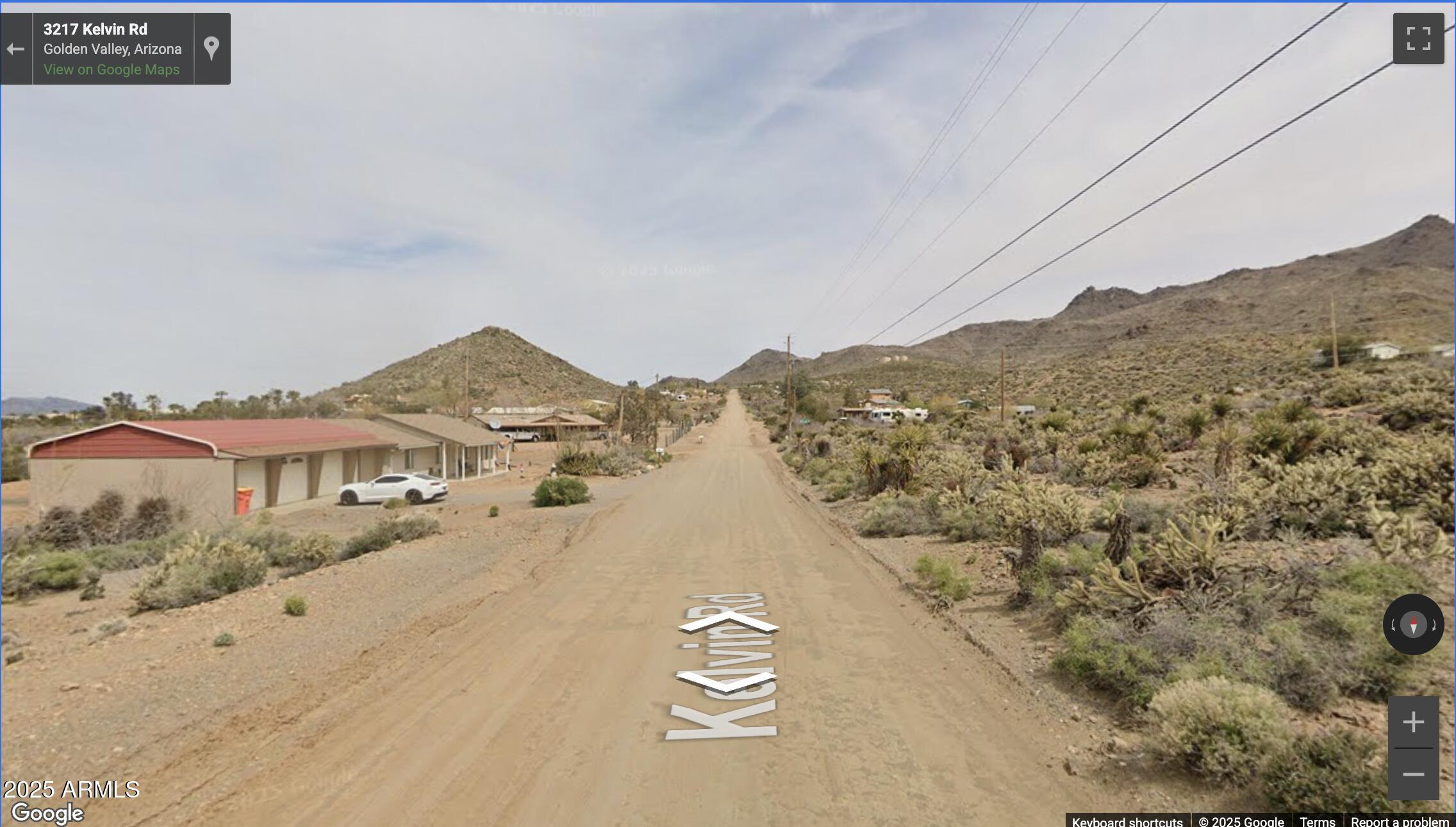 3217 Kelvin Road, Unit 1 Golden Valley, AZ 86413 - Photo 5 of 8 a view of a town with mountains in the background
