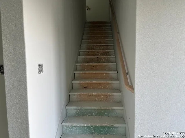 a view of a hallway with wooden shelves