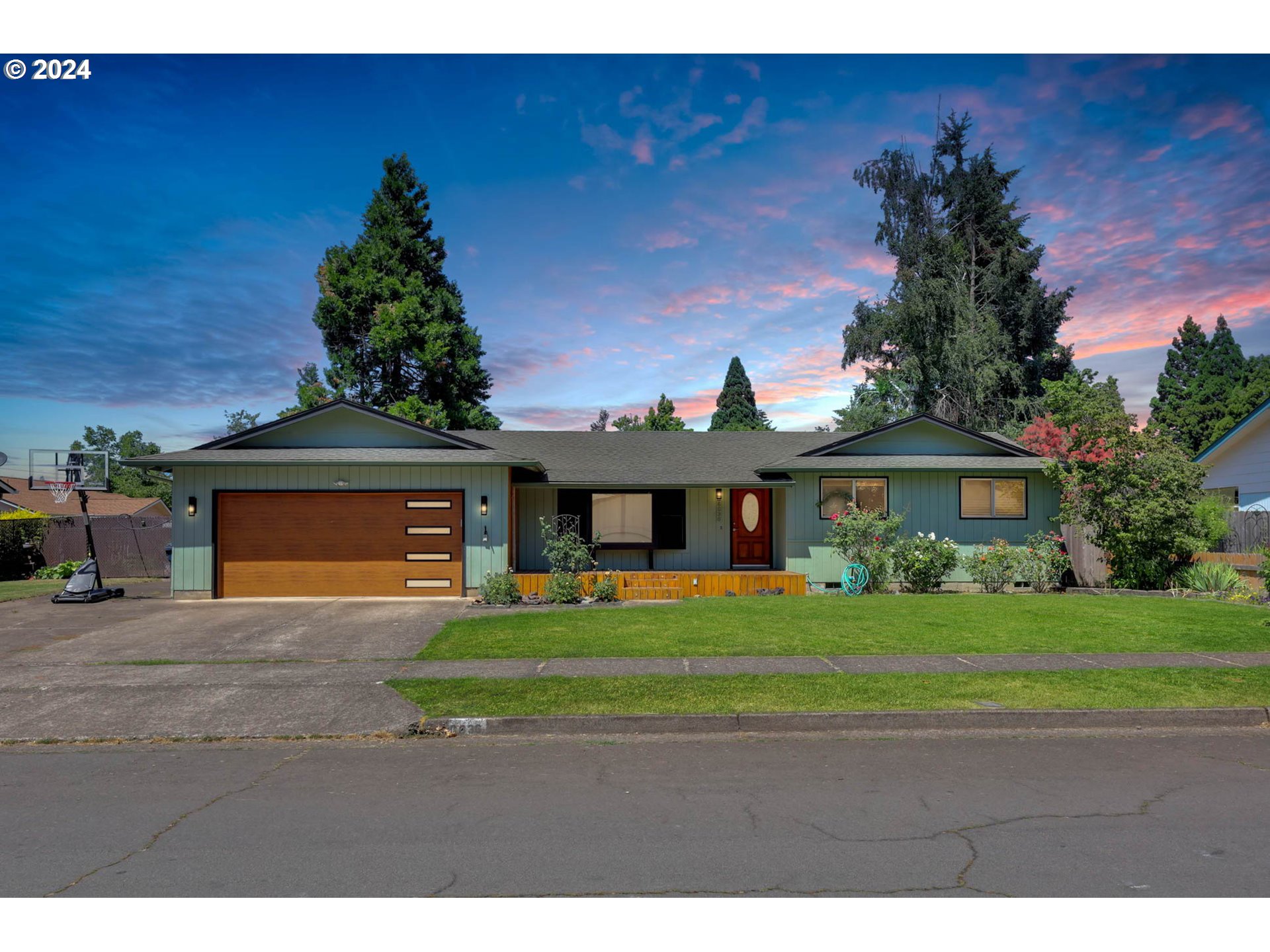 6636 E Street Springfield, OR 97478 - Photo 1 of 43 a front view of a house with a garden and trees