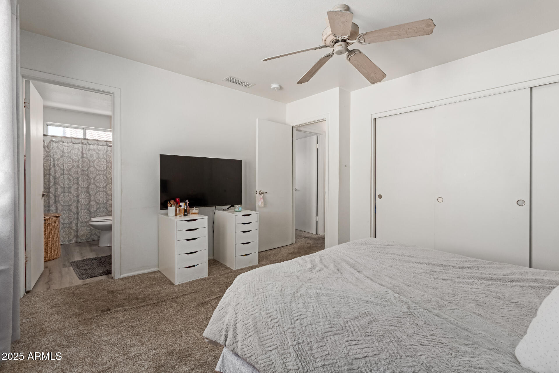 5008 Casper Road Mesa, AZ 85205 - Photo 15 of 25 a bedroom with a bed and a flat tv screen on dresser
